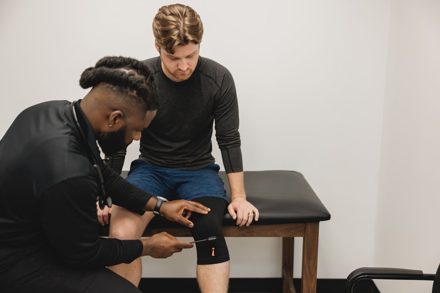 A Chiron physician examining a patient's knee