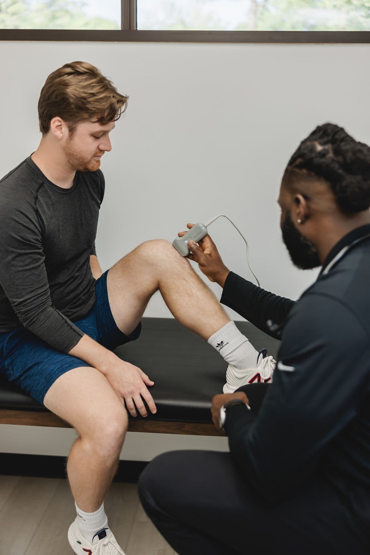 A Chiron sports medicine physician examining a patient's knee