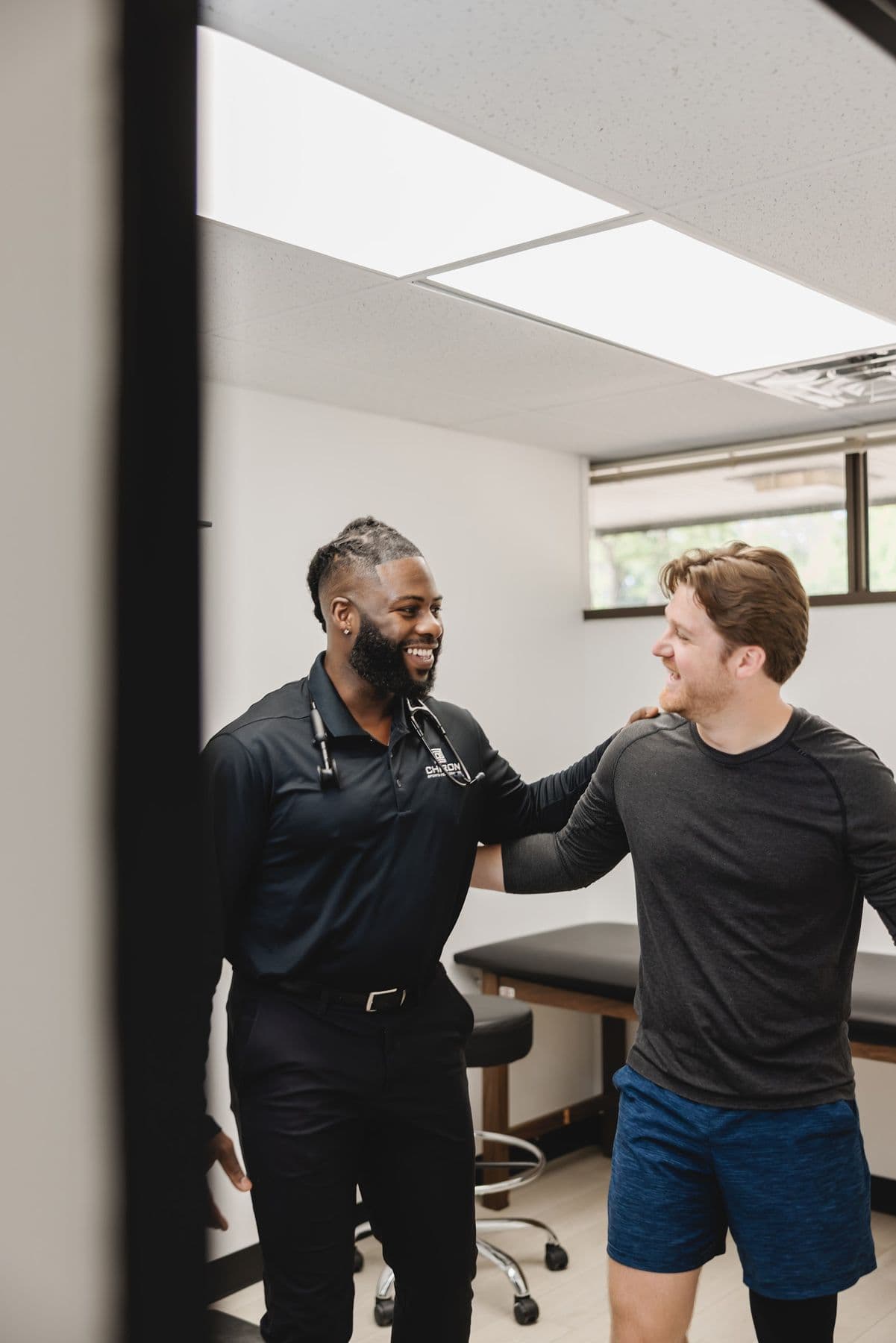 A Chiron physician and a patient smiling after a visit