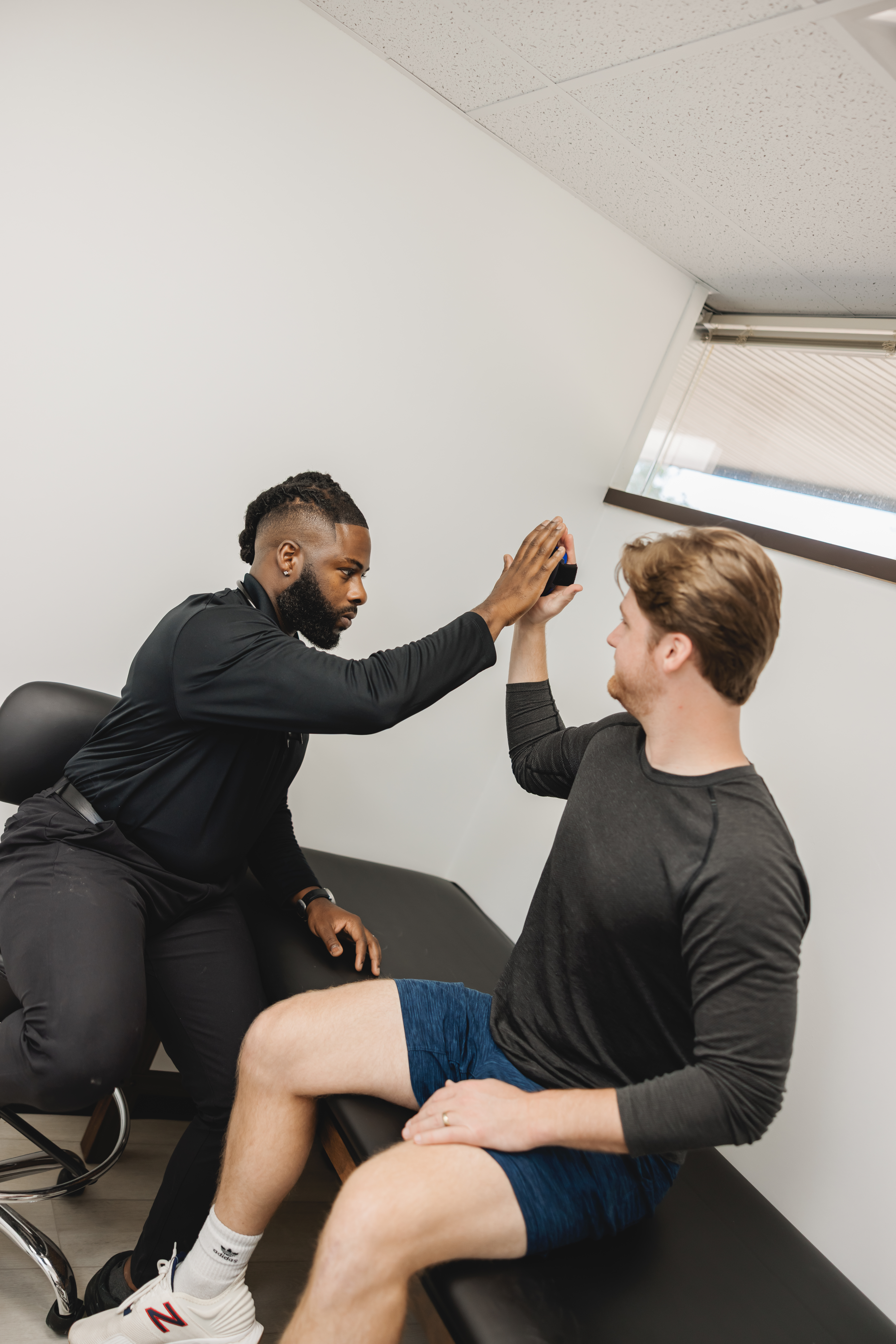 Dr. Ohanaja performing physician-led assessment at Chiron Sports Performance